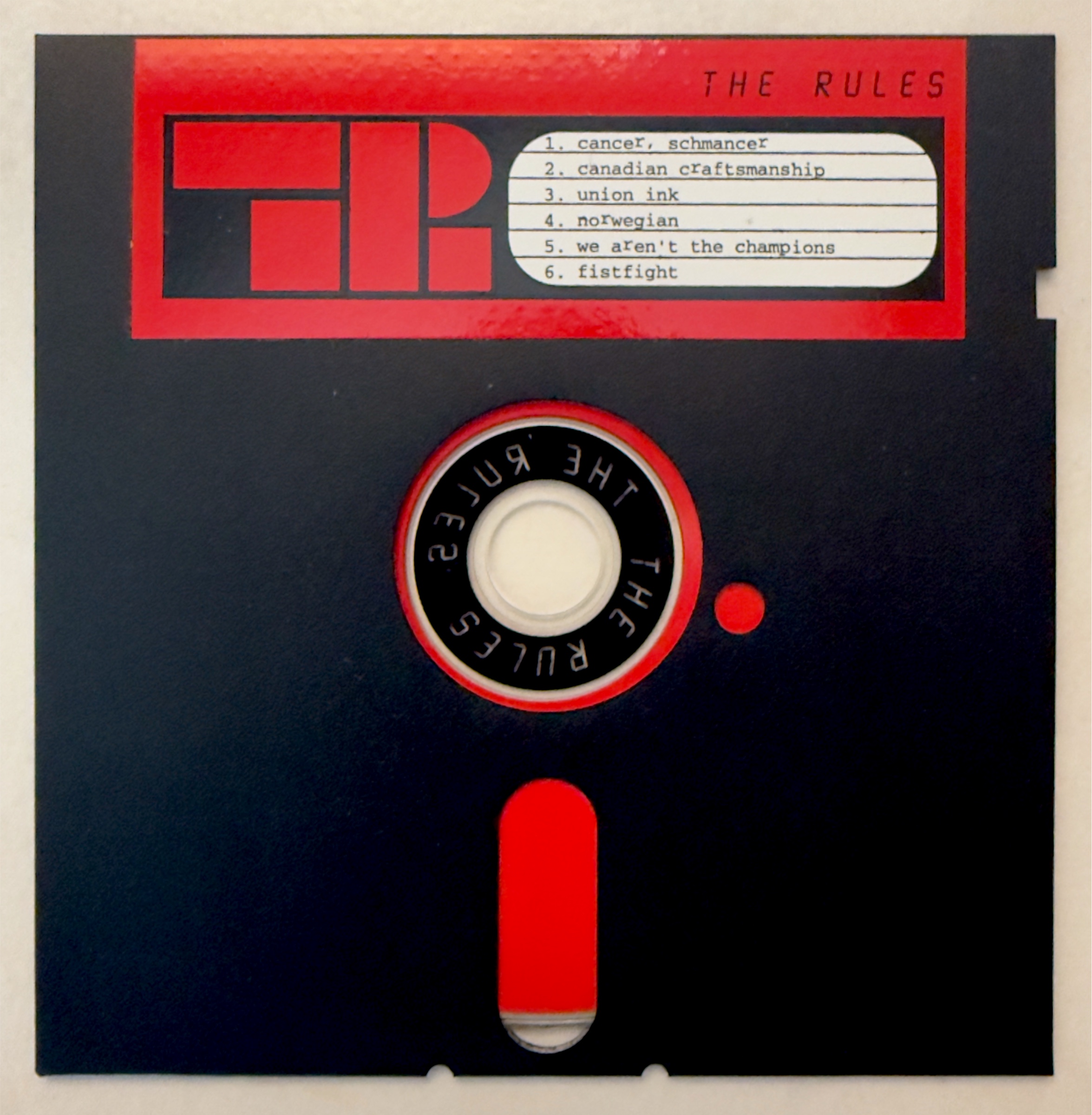 The Rules CD housed in a black floppy disk with a red printed track-list label